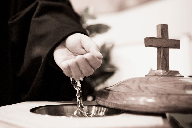 Pastor holding a hand full of water during Communion